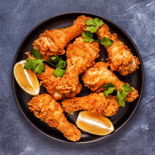 Fried chicken legs with lemon and parsley. Top view